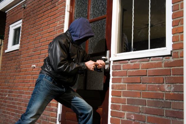 Man Breaking into home protected by DIY home security system