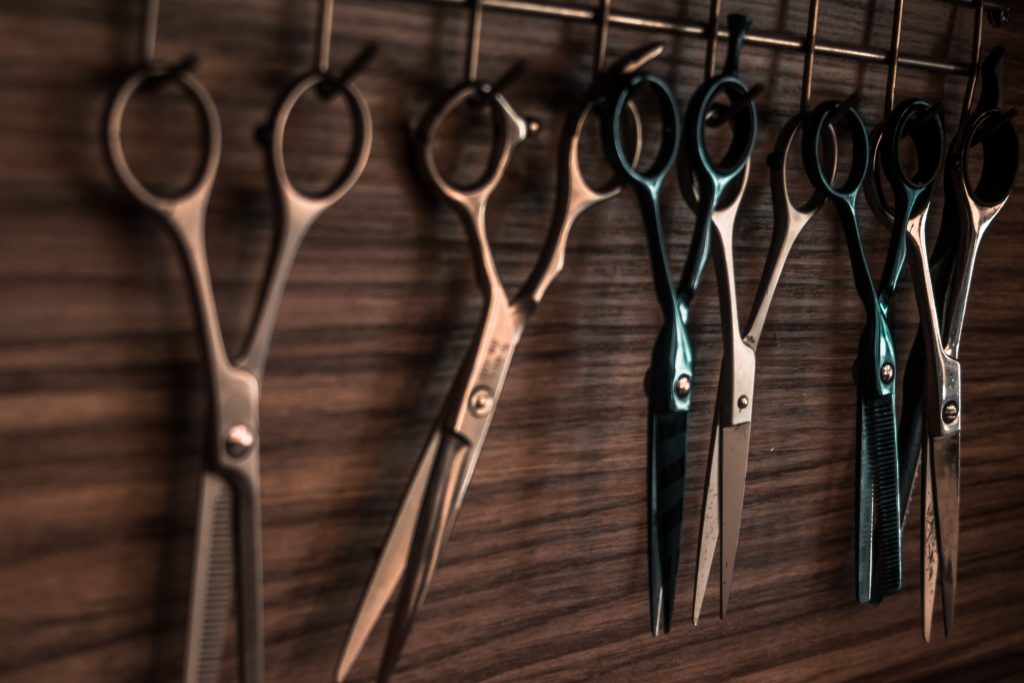 Scissors hanging on a wooden wall